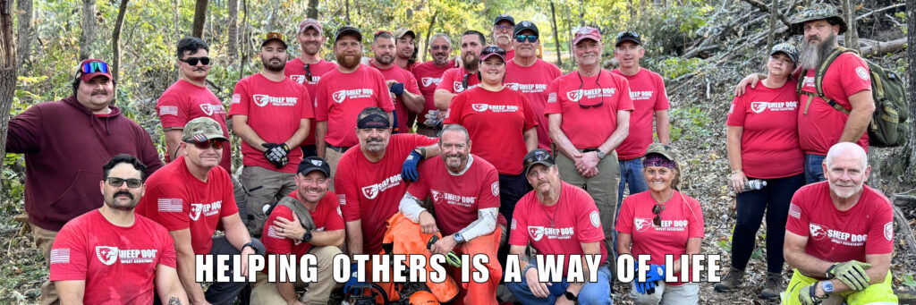 A group of Sheep Dog Impact Assistance disaster response mission volunteers clearing downed trees. "Helping Others Is A Way Of Life"