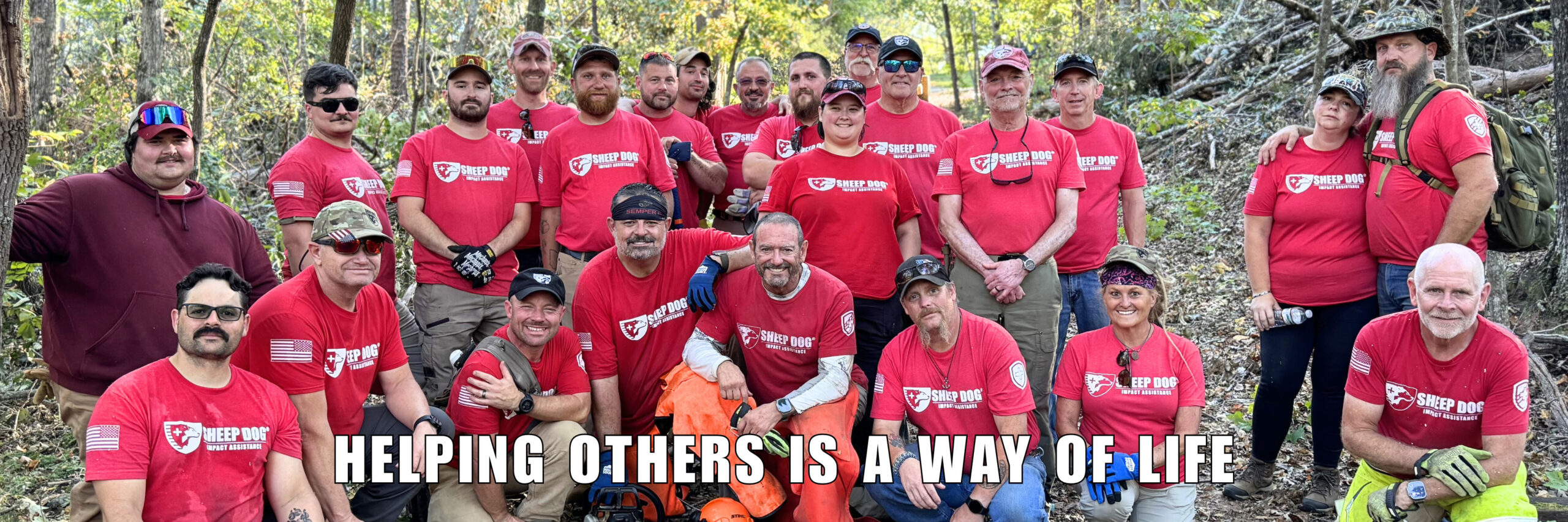 A group of Sheep Dog Impact Assistance disaster response mission volunteers clearing downed trees. Helping Others Is A Way Of Life
